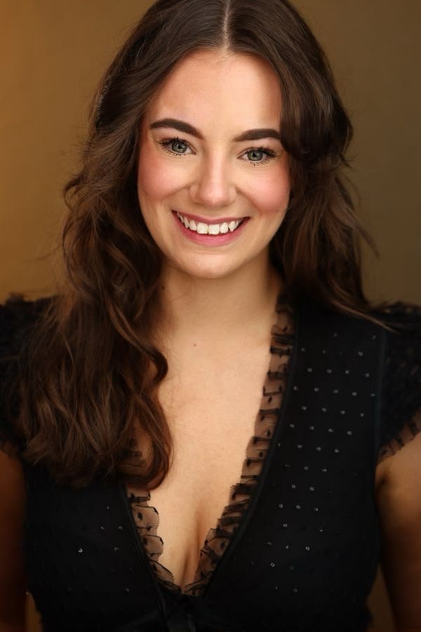 Topaz smiling in a black top