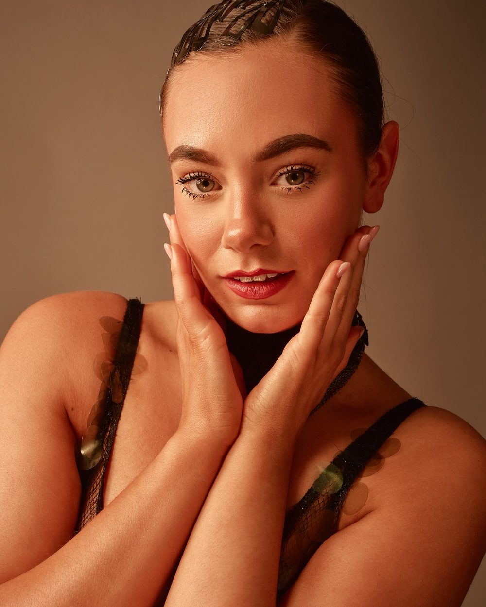 Portrait of Topaz with her hands framing her face
